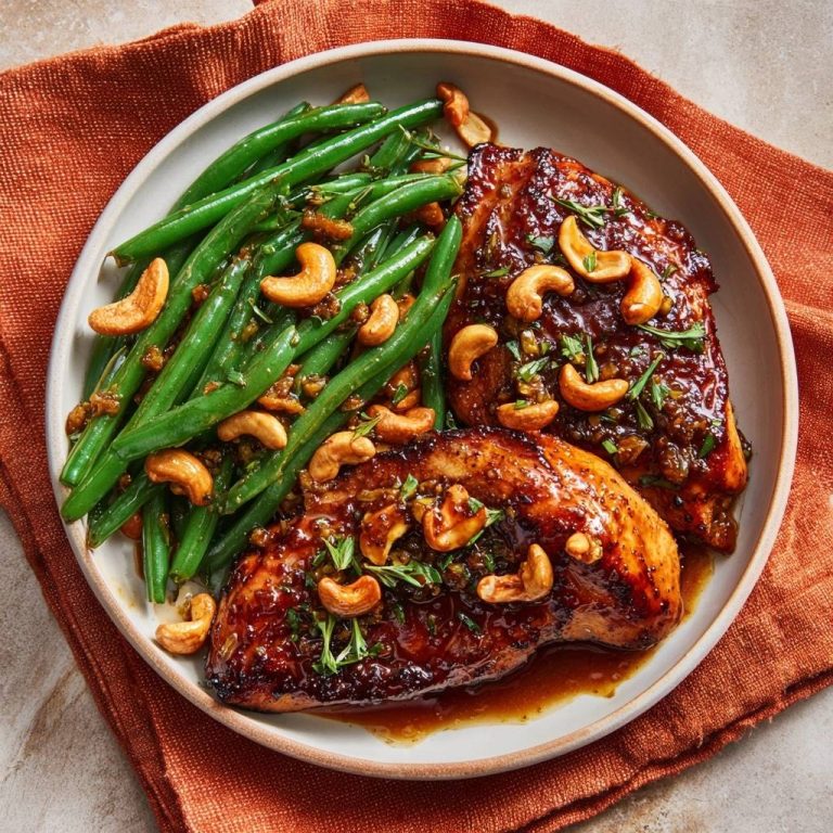 Saftiges Teriyaki-Hähnchen mit Cashew-Bohnen, serviert auf einem Teller mit grünen Bohnen und Cashewkernen aus der Vogelperspektive.